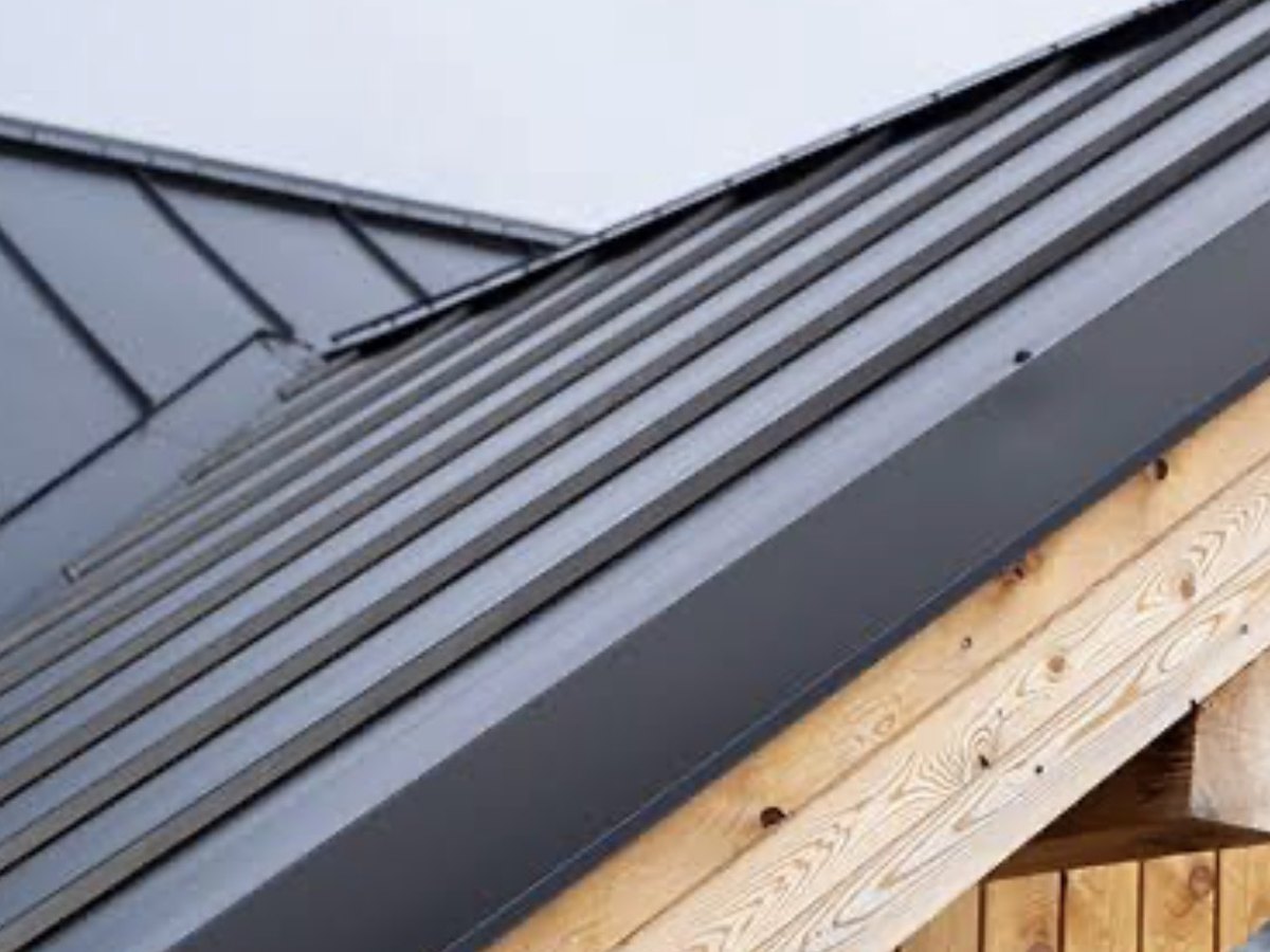 New metal roof fitted over a timber-clad building
