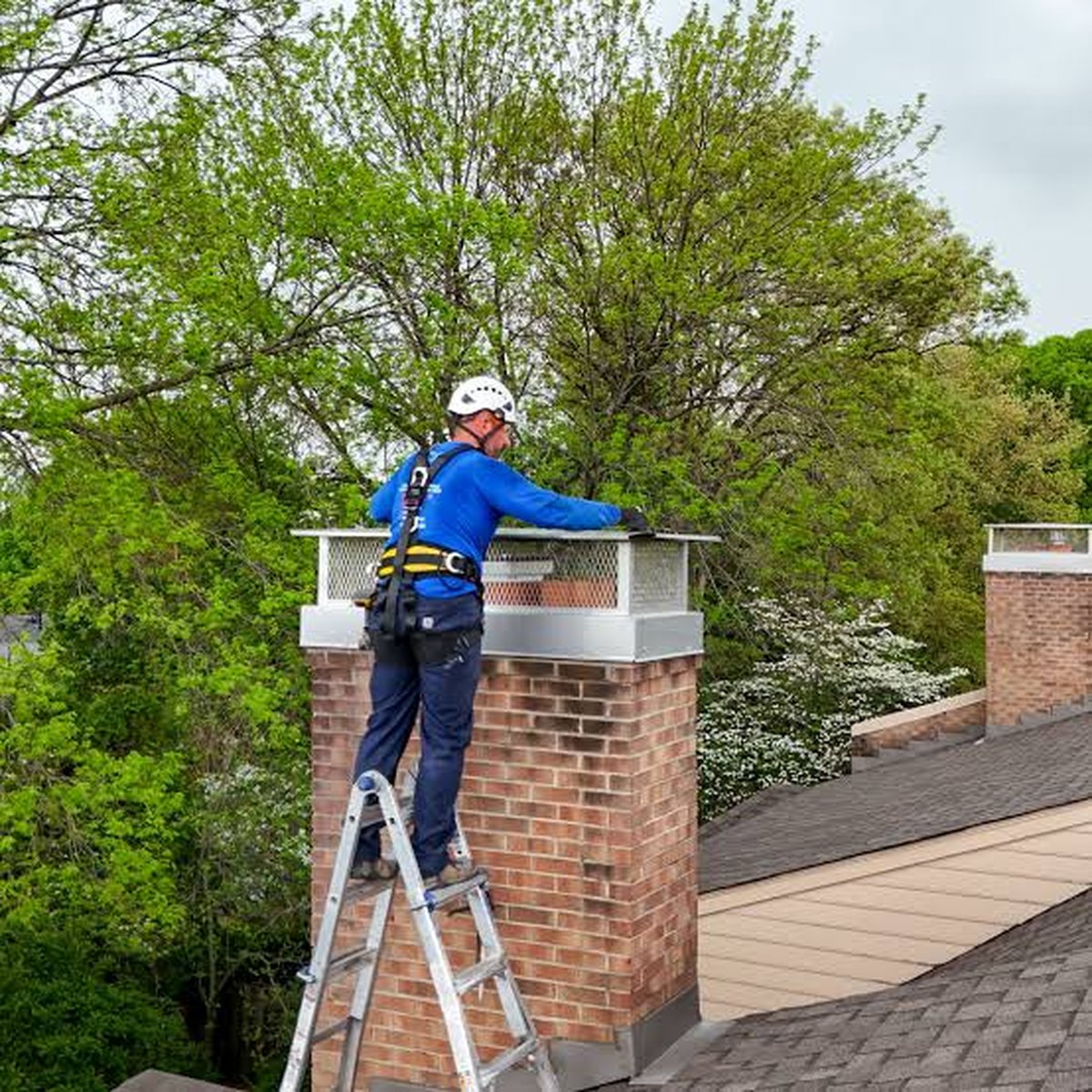 Roofer working on a brick chimney stack