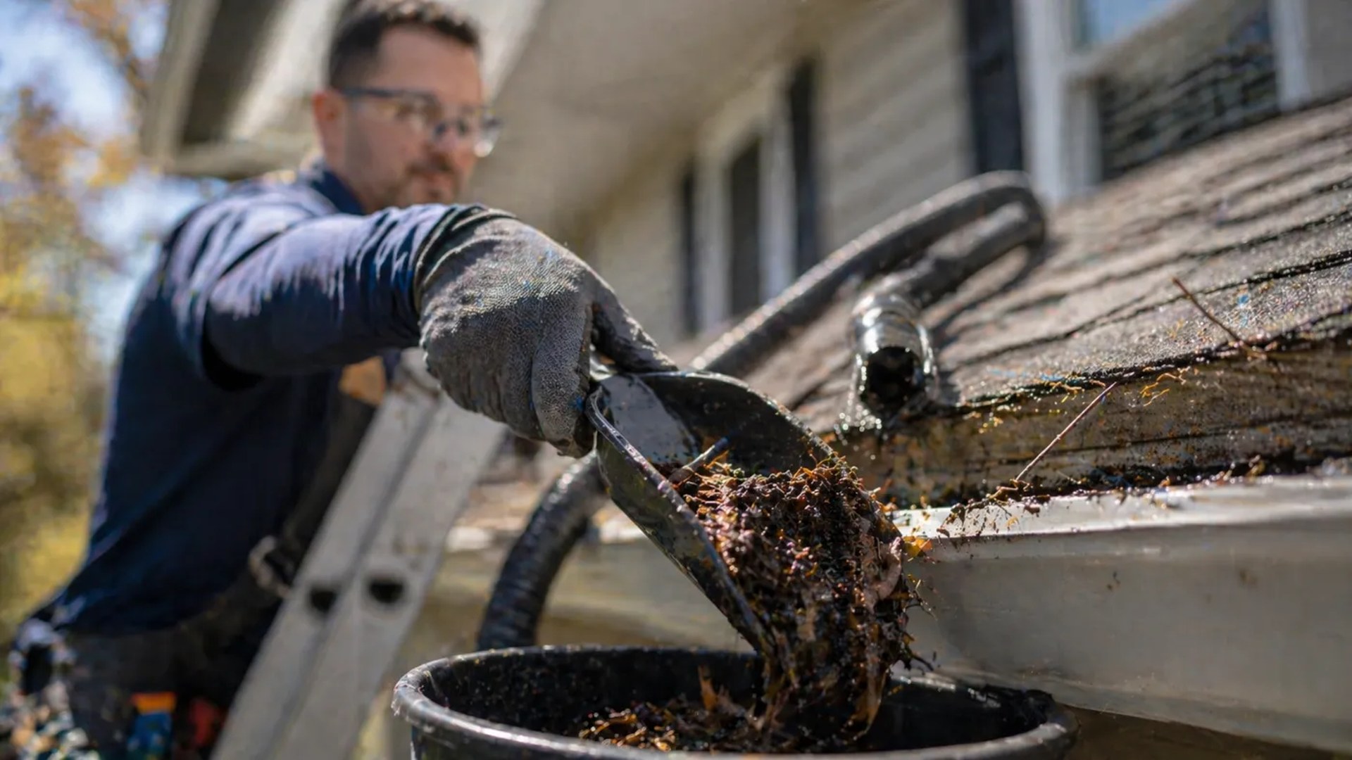 Debris being cleared from a blocked gutter