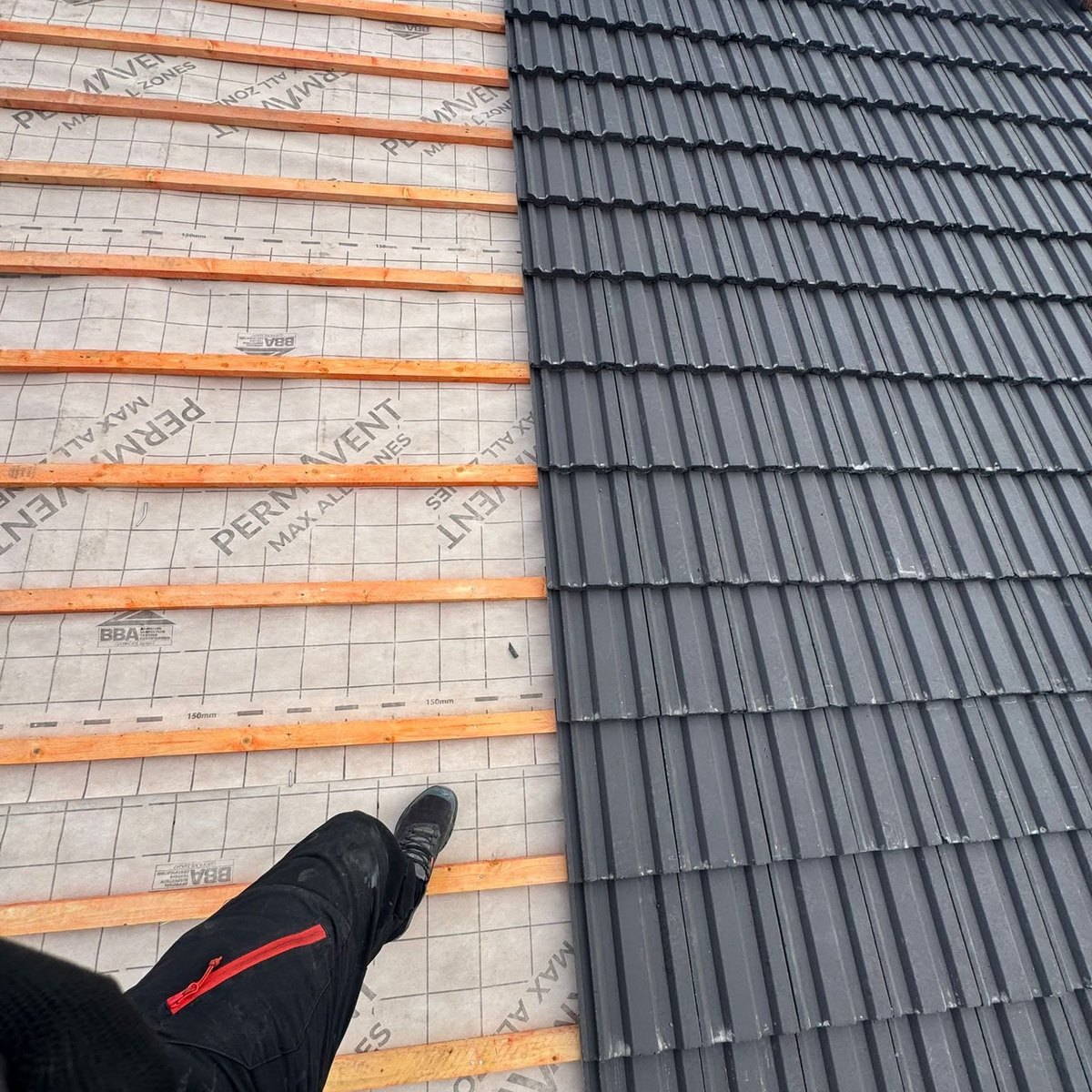 New tiles being laid over breathable membrane