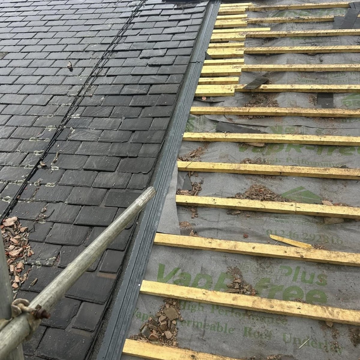 Roof being re-slated over new battens